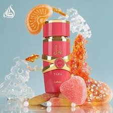 Silk and Sillage Lattafa Yara Candy perfume bottle with a pink and gold design, 100ml, displayed on a white background.